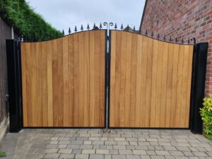 Arched timber driveway gate with steel detail