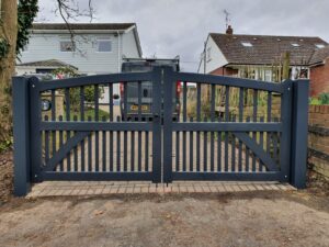 Arched slatted pair of gates