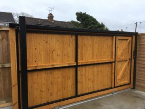 Solid sliding gate with wicket door